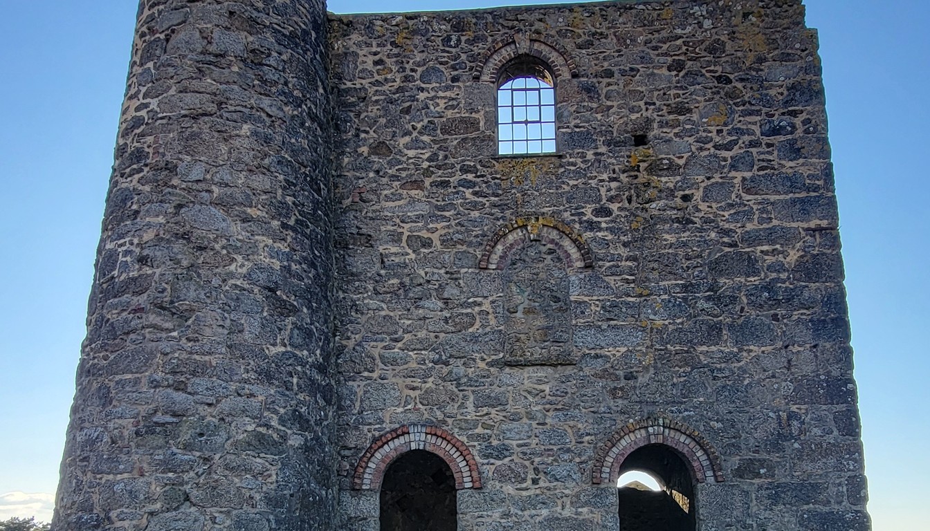 Cornish engine house with red brick arches and chimney stack