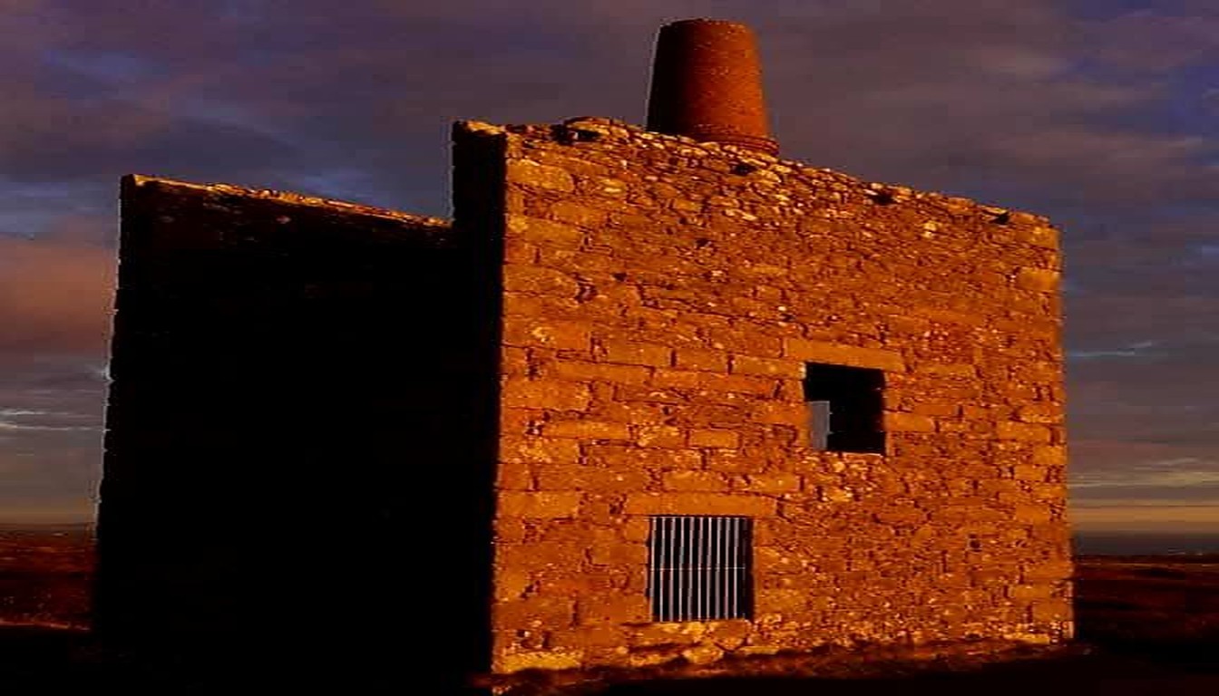 Cornish engine house bathed in golden sunset light
